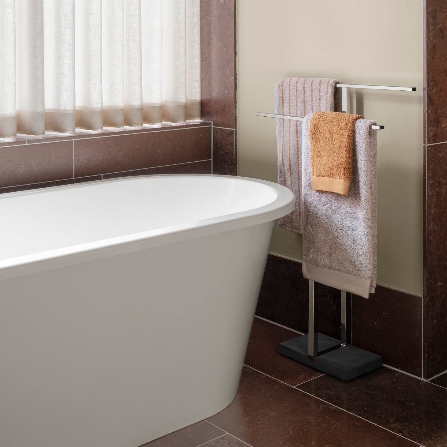 MENOTO brushed stainless freestanding towel rack in a modern bathroom