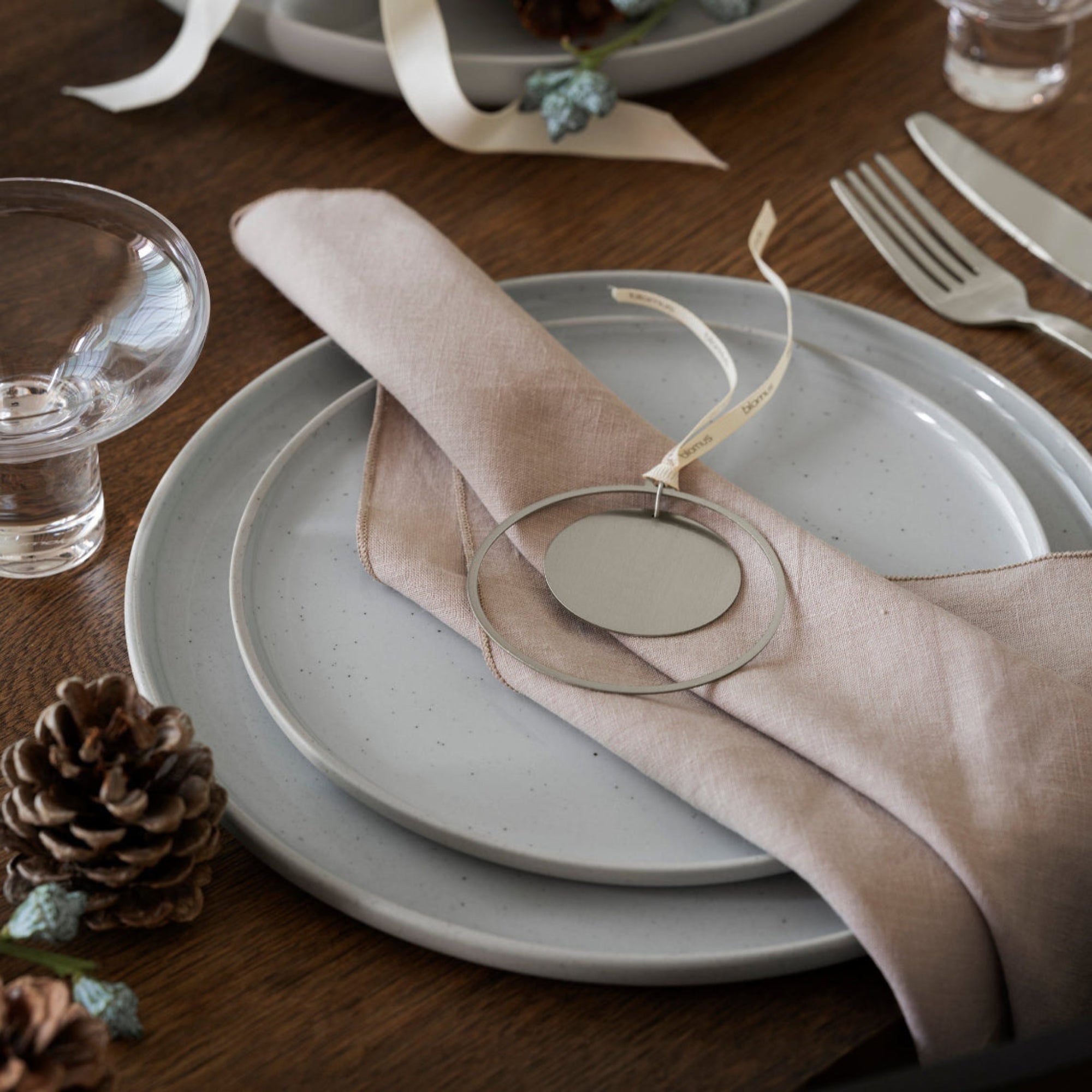Holiday dinner setting with stainless ornament with ribbon hanger by blomus KITAI