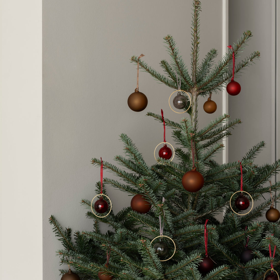 Christmas tree with deep red and brown glass bubble ornaments from blomus