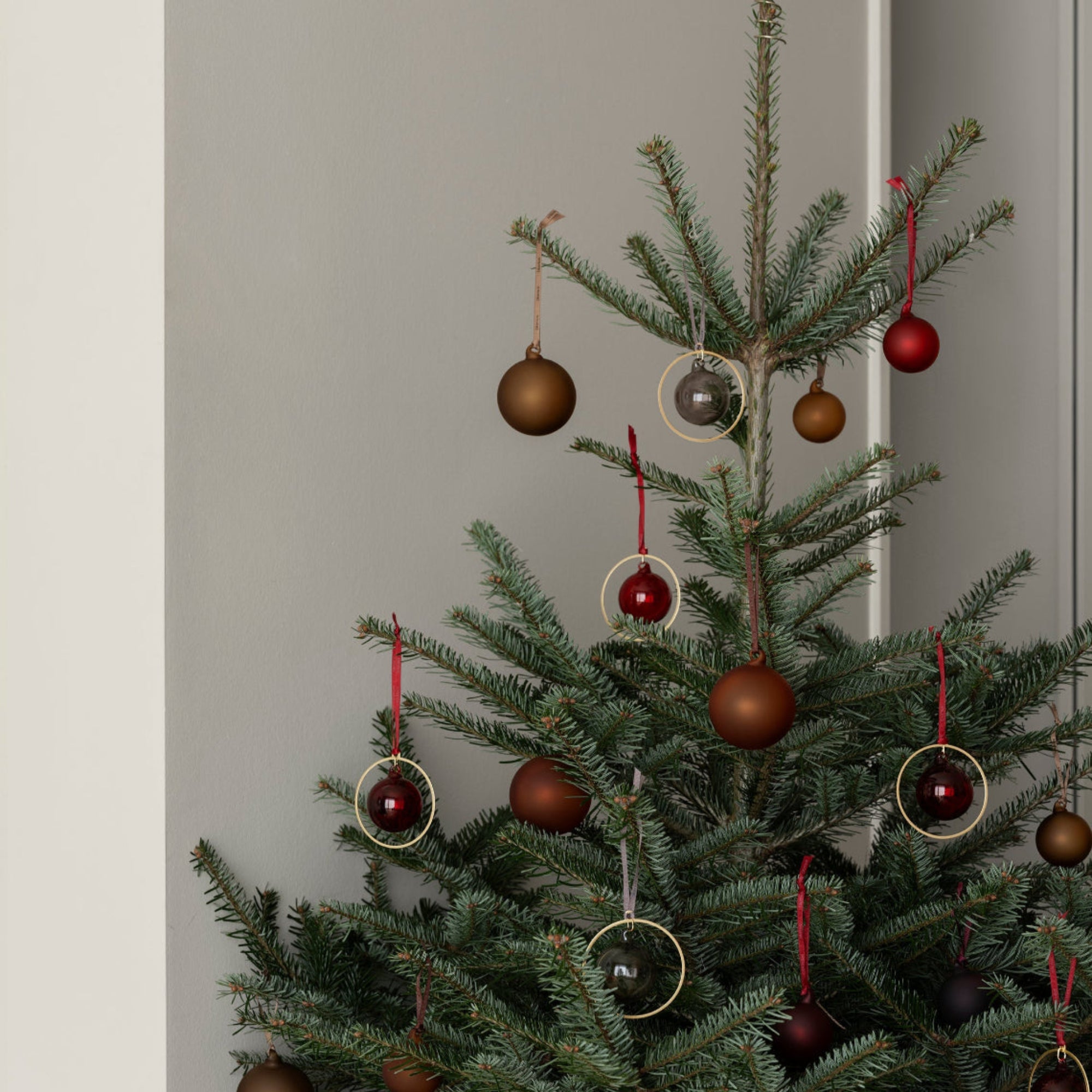 Christmas tree with deep red and brown glass bubble ornaments from blomus
