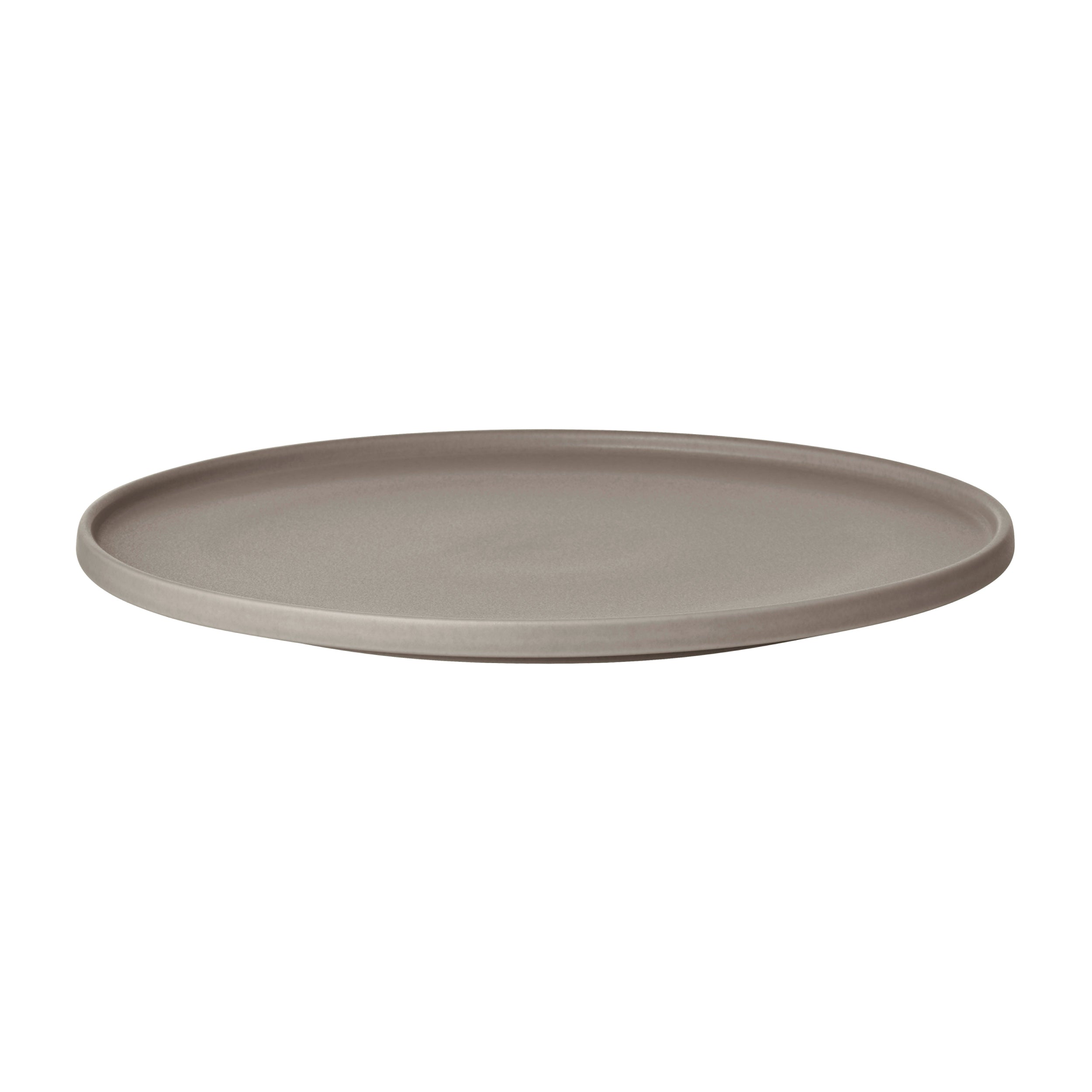 Round beige ceramic plate on a white background