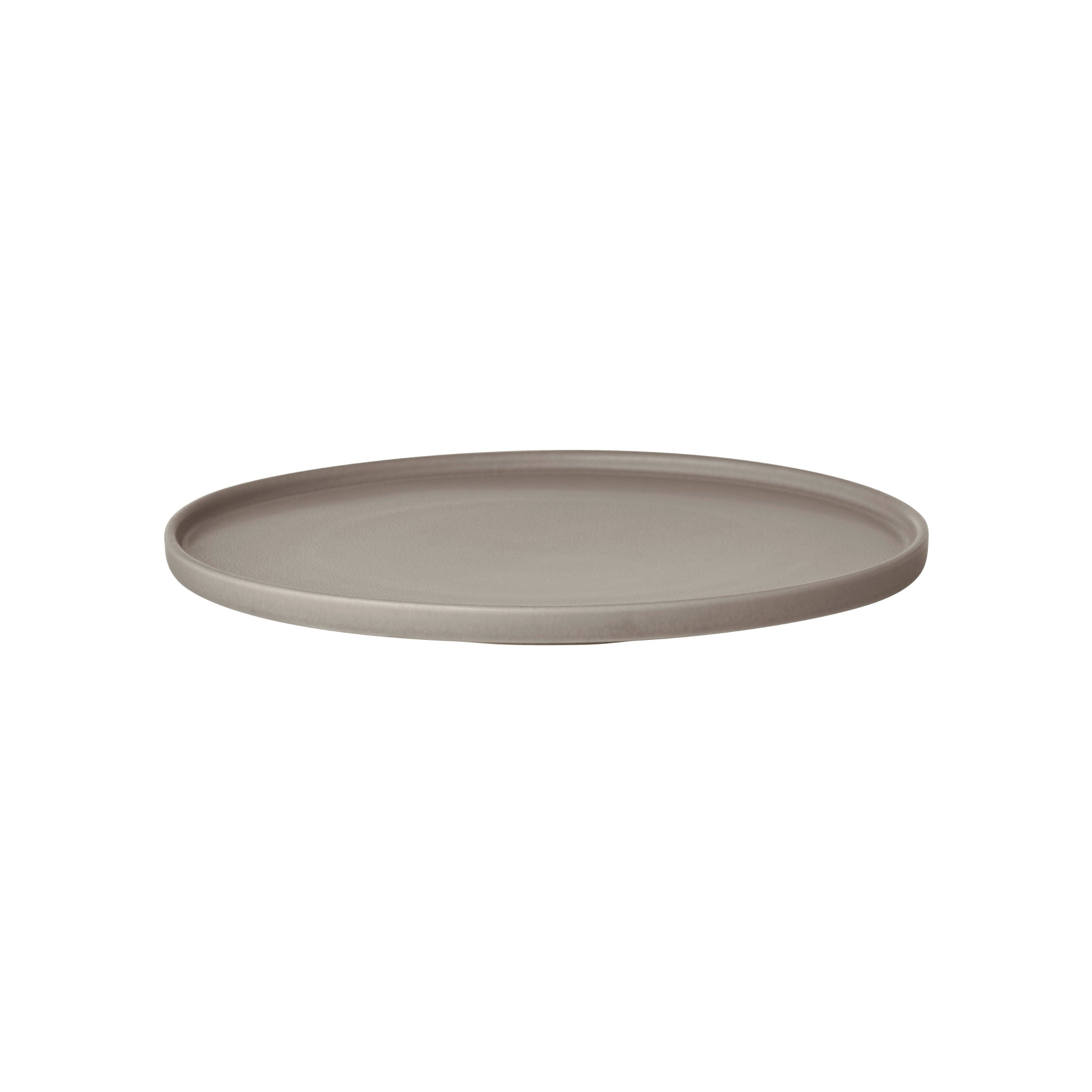 Round beige ceramic plate on a white background
