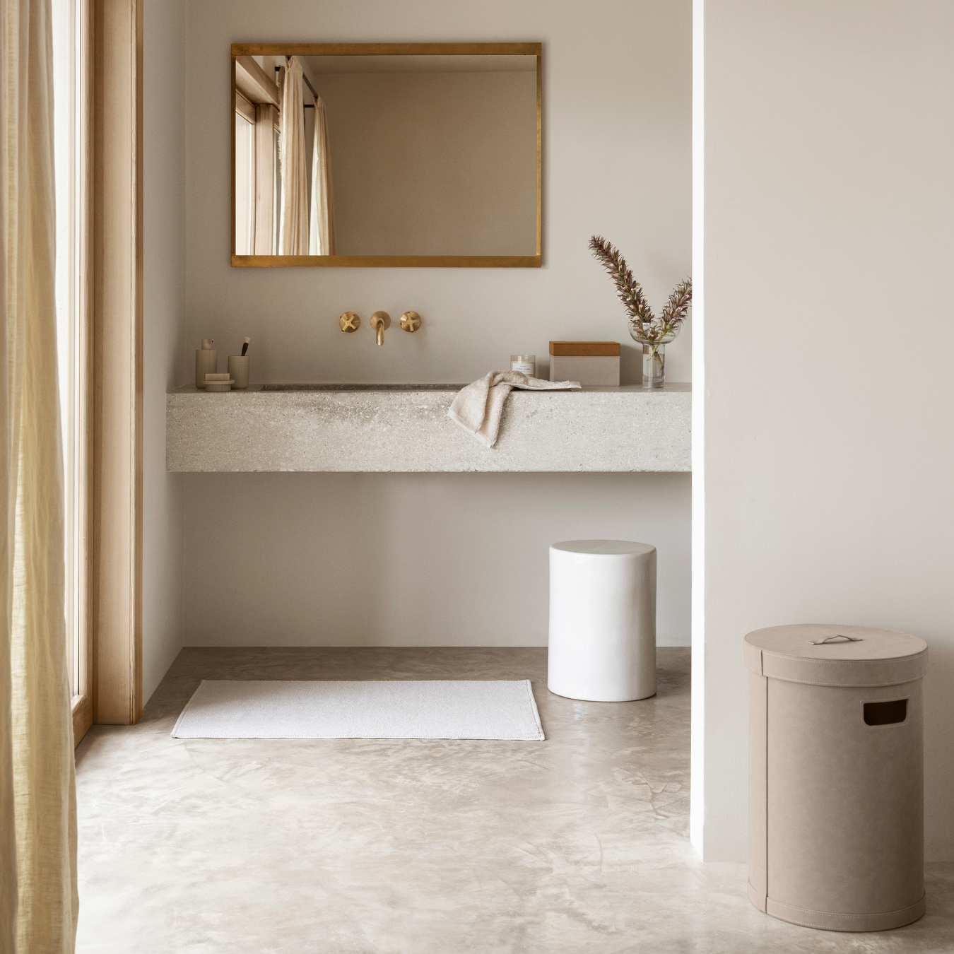 Modern bathroom with concrete sink, gold fixtures, and neutral tones. SAHLA Jewelry Boxes on sink countertop.