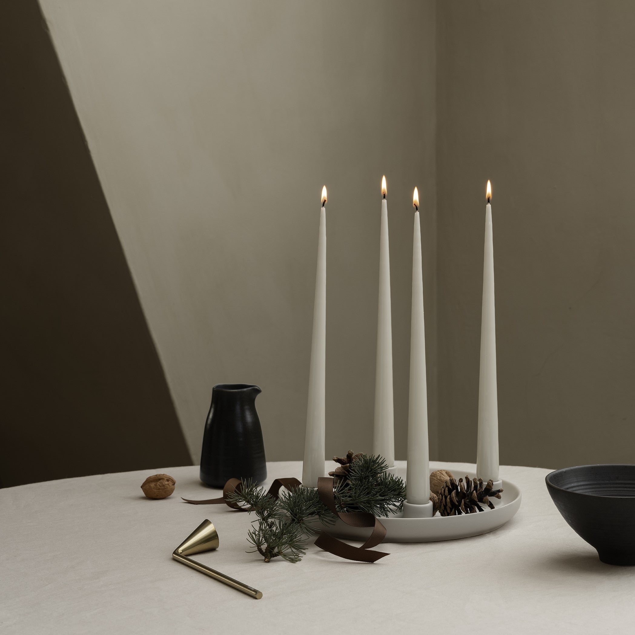 Holiday dining table setting with candles and blomus NOX brushed brass finish candle snuffer
