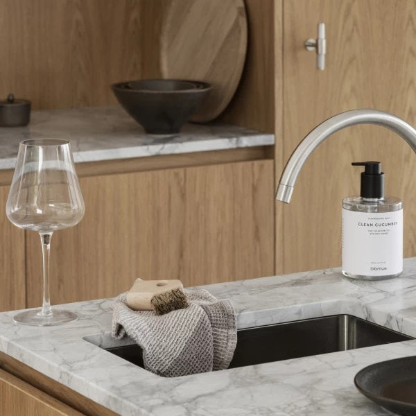 blomus AVES bristle brush next to tidy kitchen sink