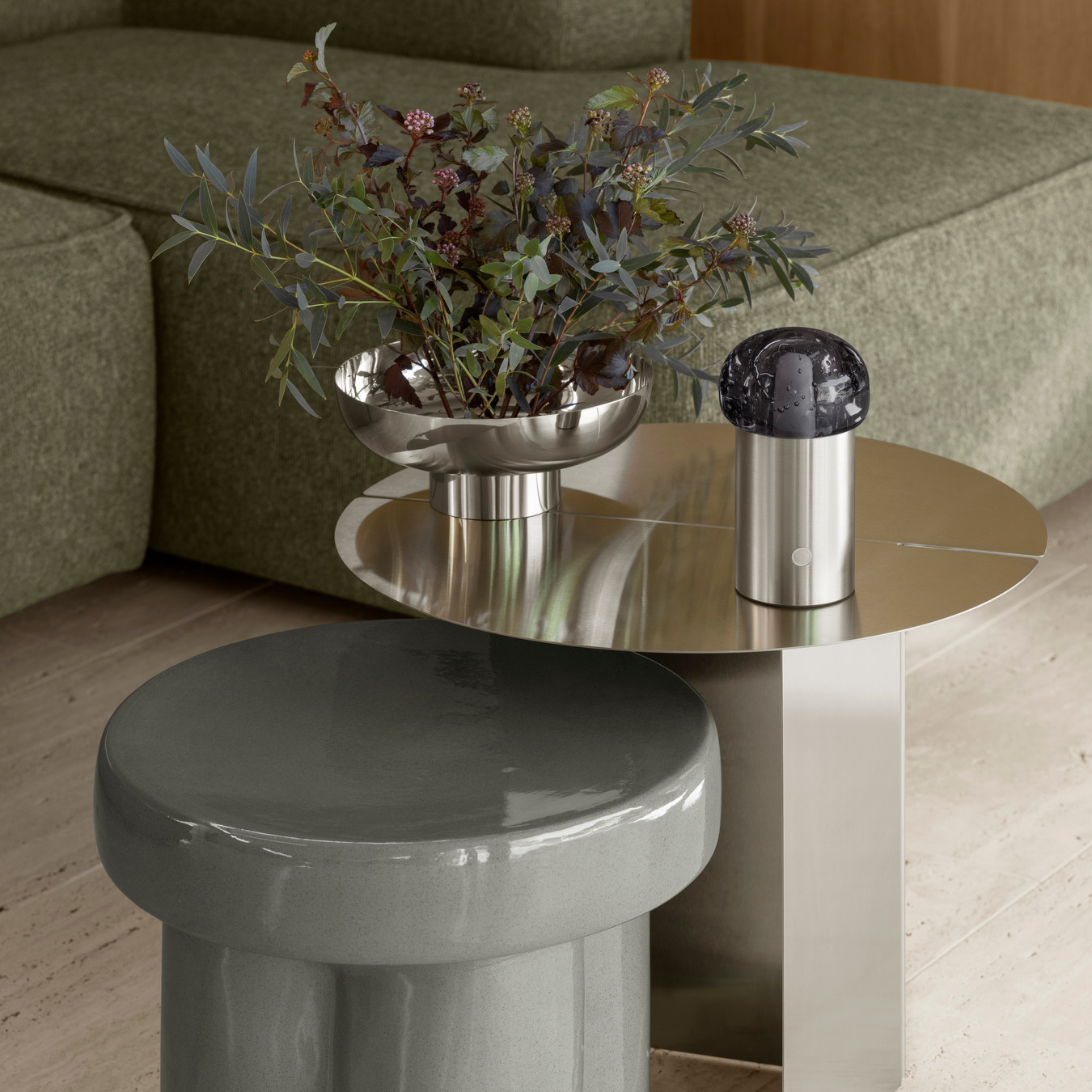 polished metallic MIYABI vase on a modern side table in front of green lounger