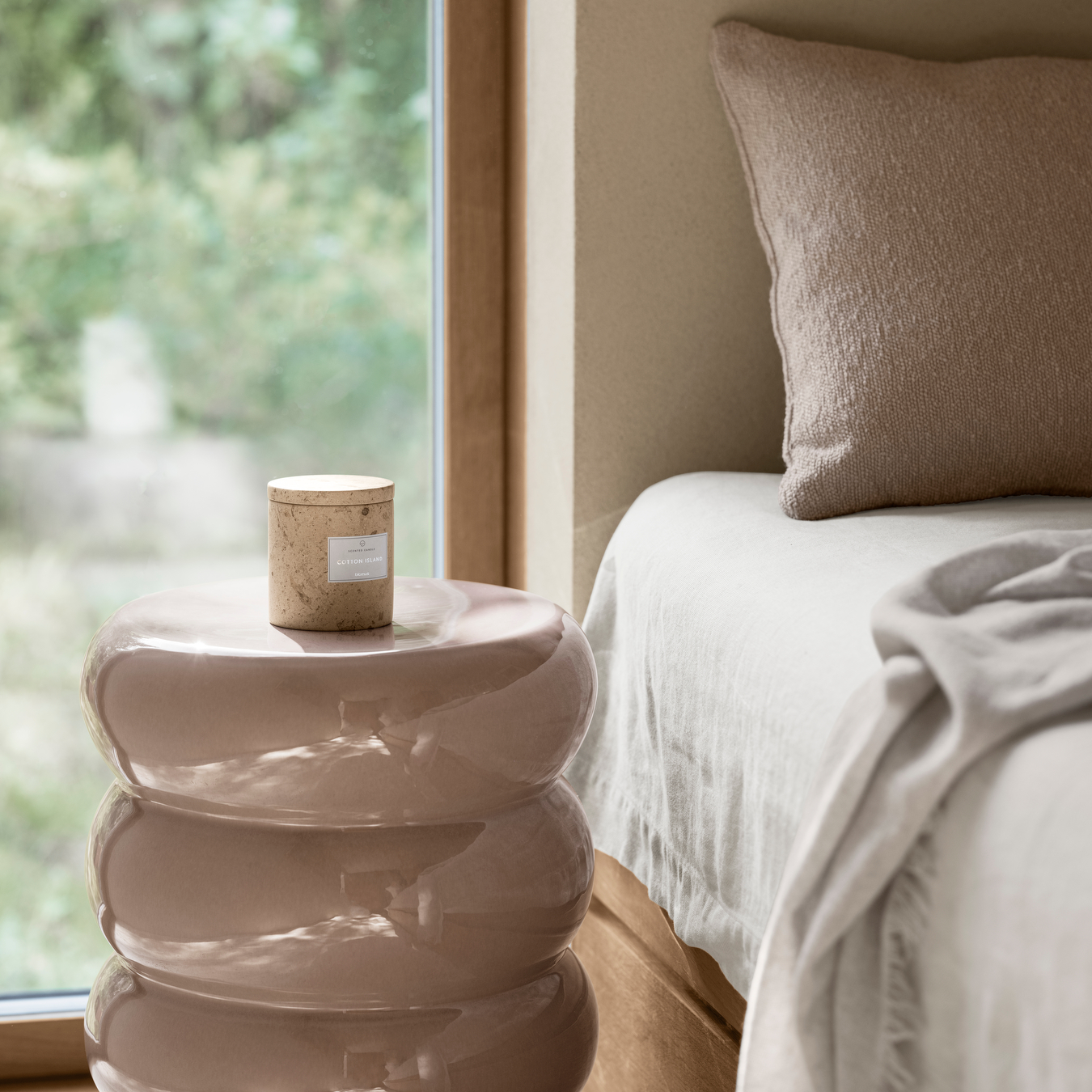 glazed ceramic TORU side table by blomus in a simple bedroom setting