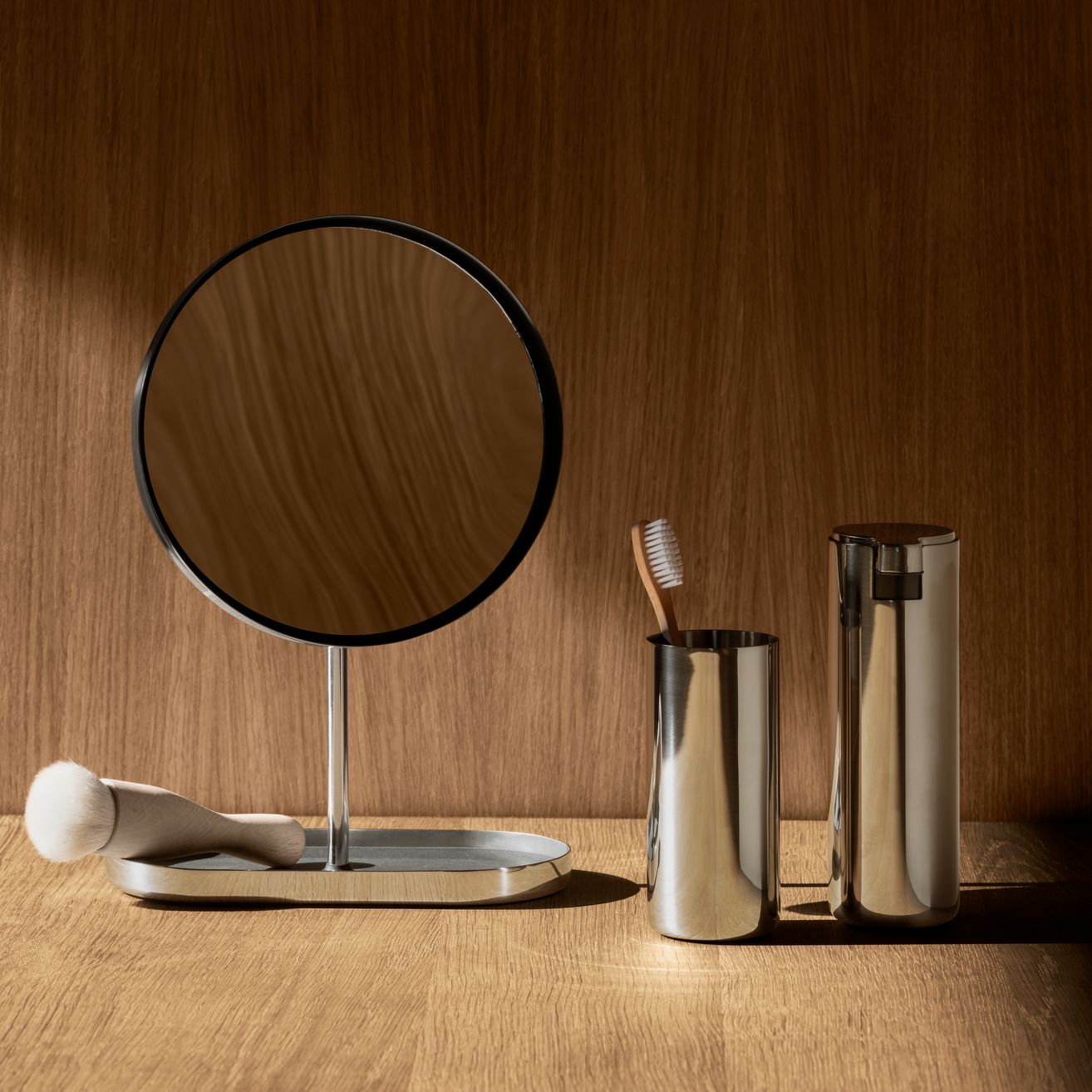 Simple polished stainless bathroom set on a wooden surface