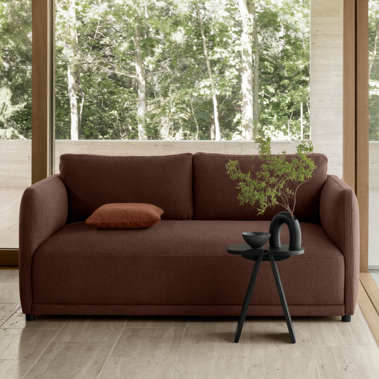 Modern seating area with sleek black KOGETSU vase and decorative branch on a small black side table
