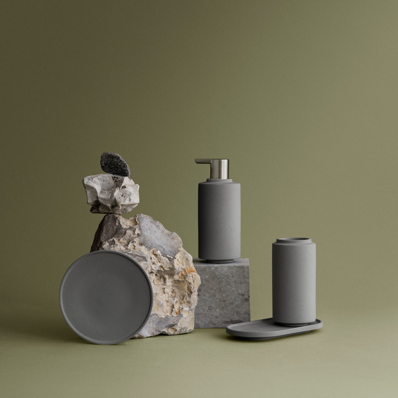 modern minimalist bathroom accessories from blomus CRETO collection displayed against a simple green backdrop