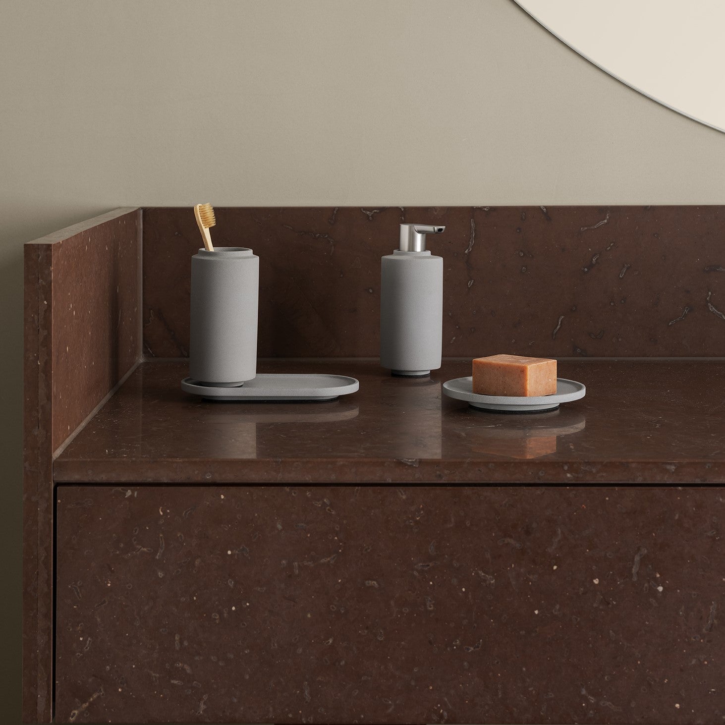 Chic bathroom setting with Rosso Levanto marble counters and minimalist bathroom accessories from blomus