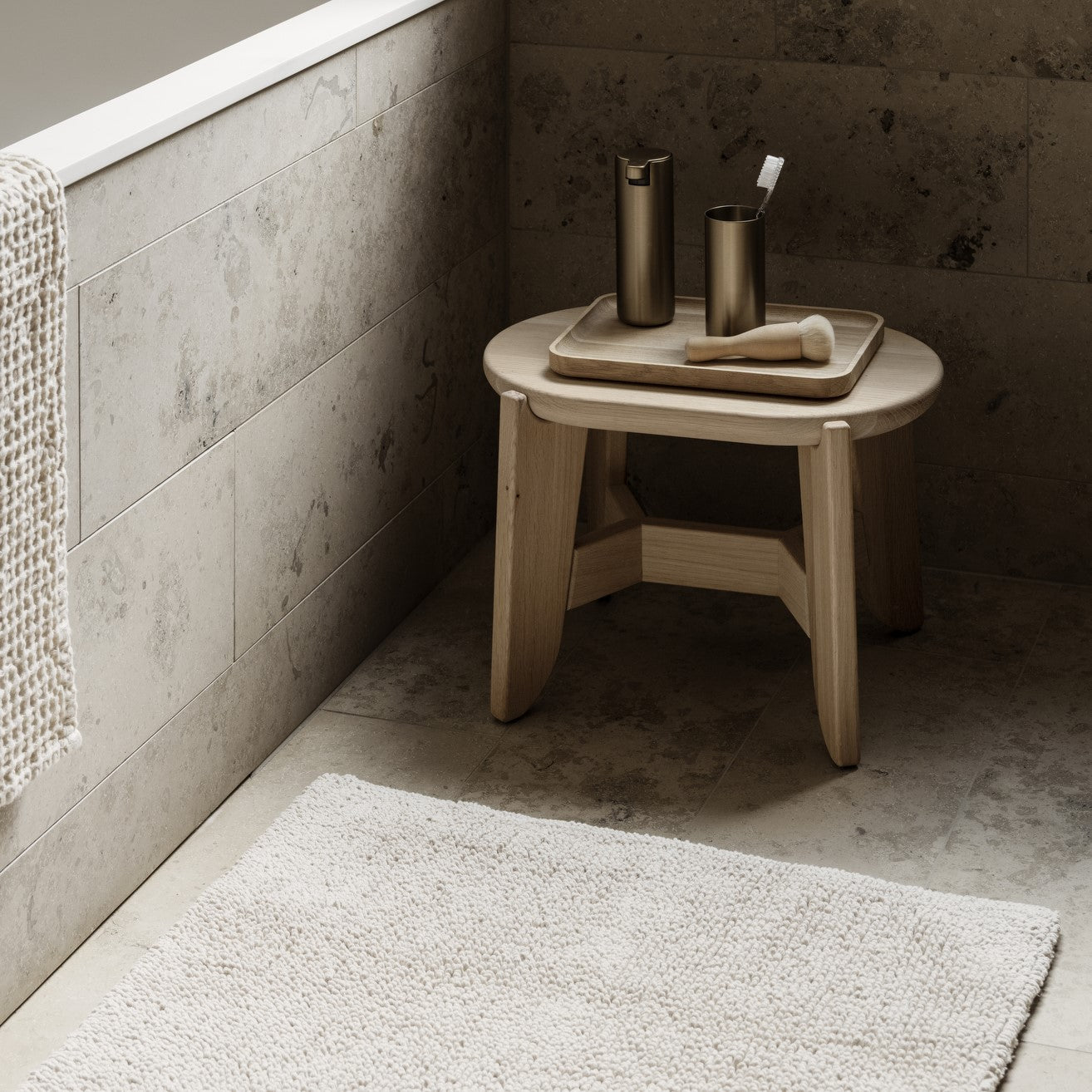 OKU rectangular oak wood tray on wooden stool in a chic marble bathroom