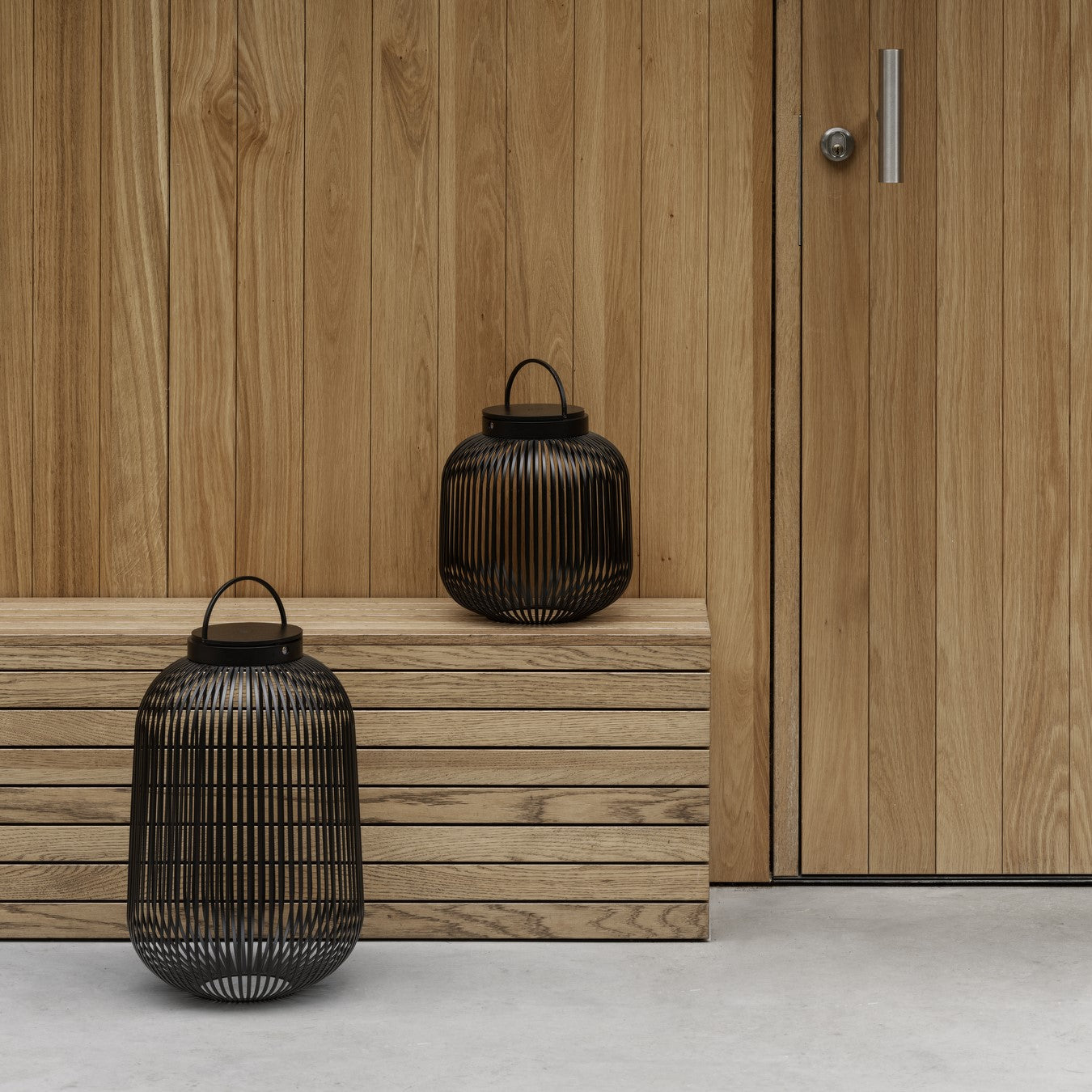 Wooden walls and bench with LITO LED wire lanterns next to a door