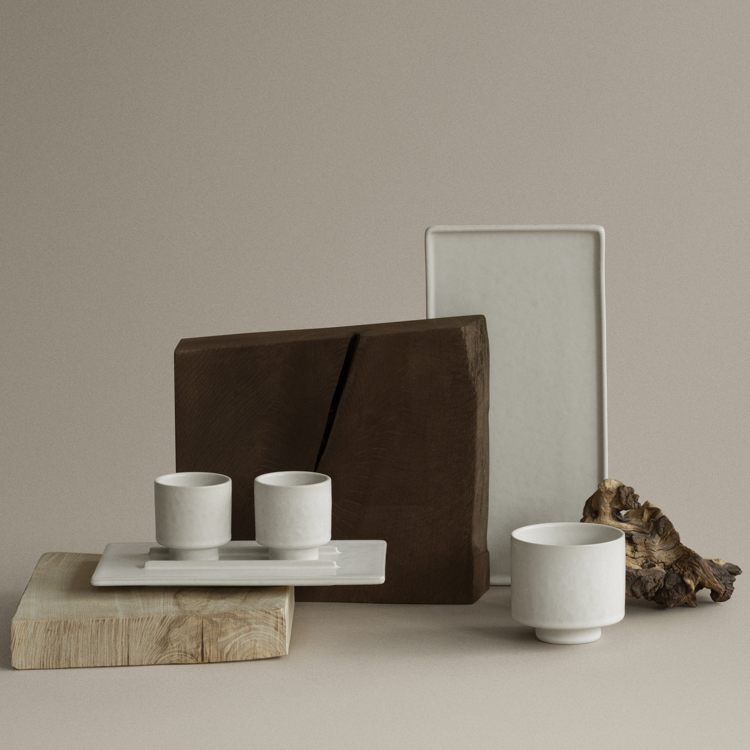 MAKOTO cups and dishes with a wooden board on a neutral background