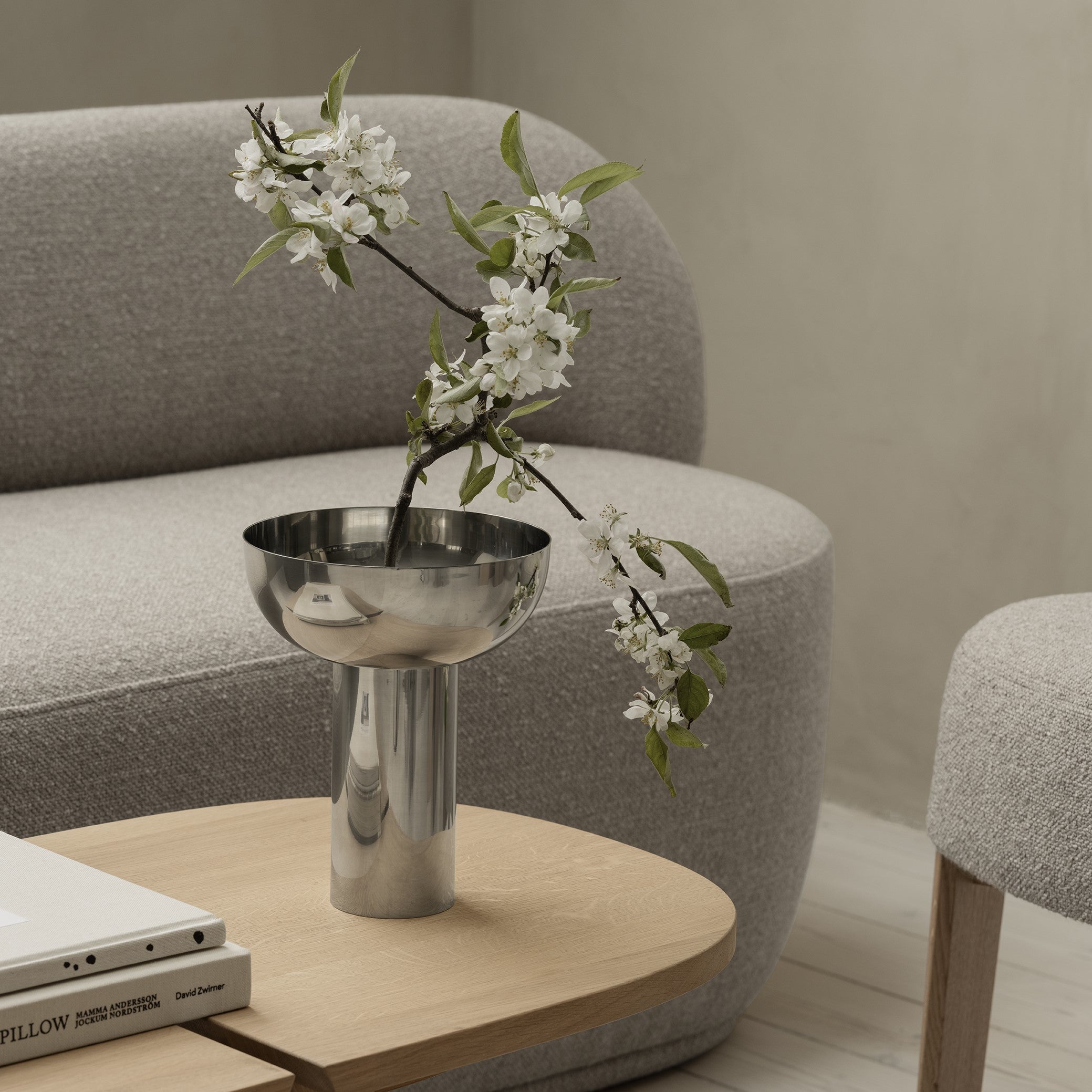 modern sitting area with polished stainless steel MIYABI vase inspired by Japanese art of ikebana