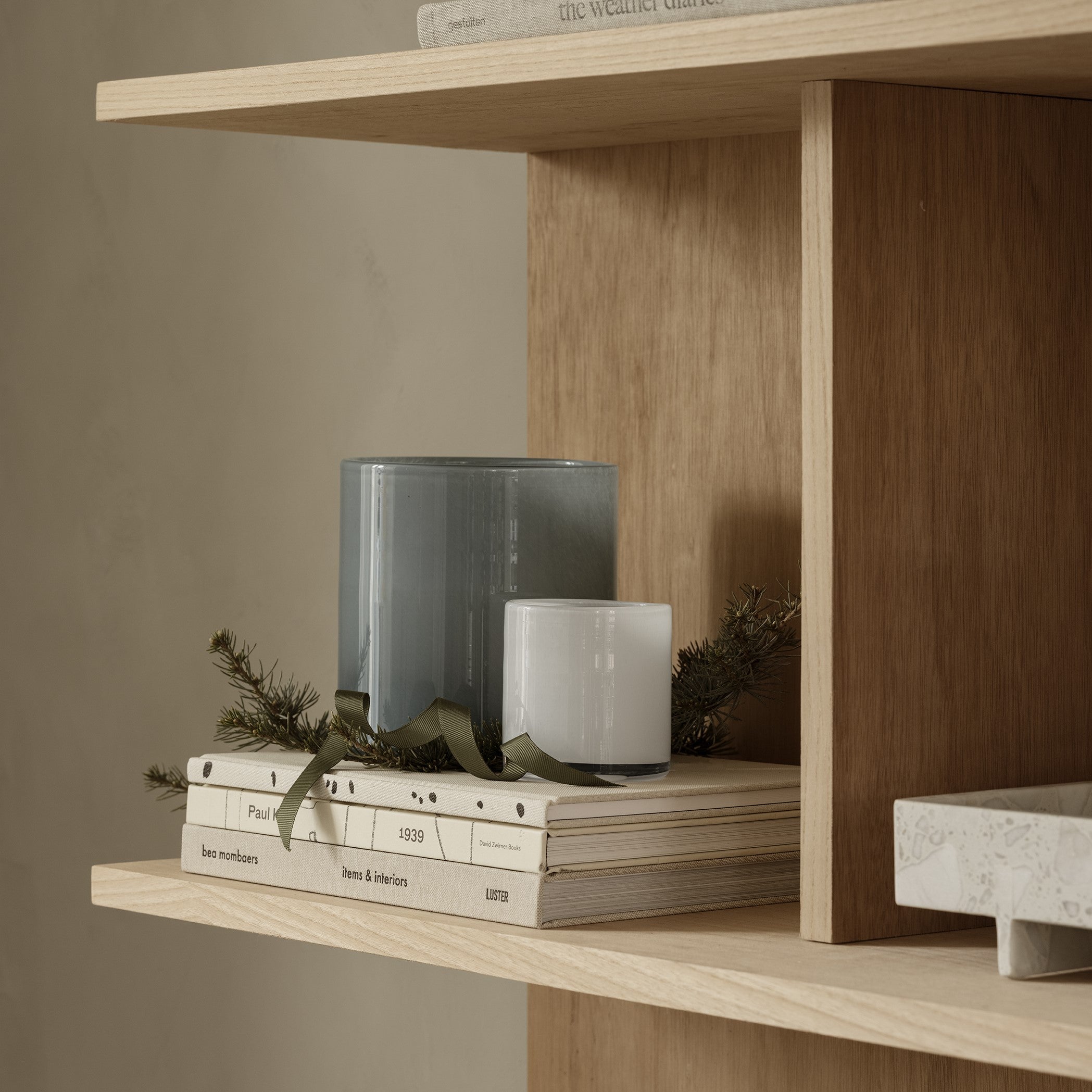 SAGA handblown glass hurricane lamps displayed on wood shelves