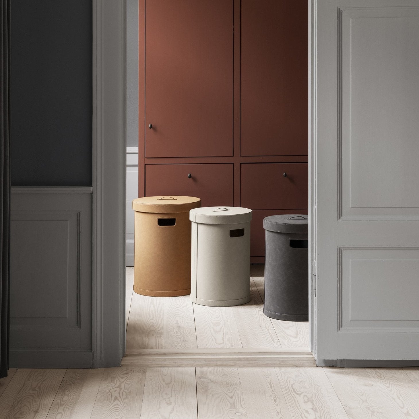 multiple sizes and colors of SAHLA cylindrical decorative storage bins in a closet