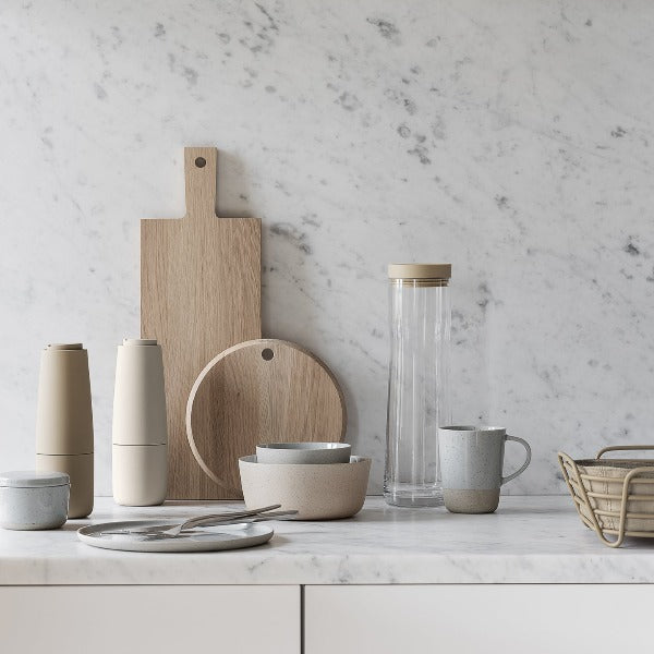 elegant marble countertop displaying various kitchen accessories from blomus including SALPI adjustable spice grinders