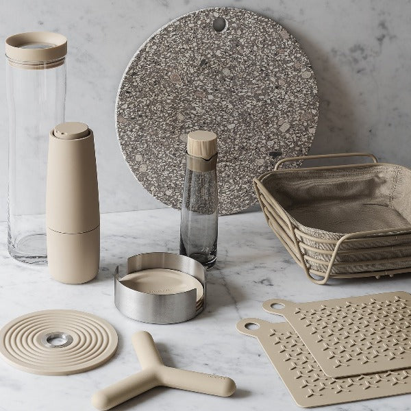 marble counter displaying various kitchen accessories with blomus DELARA wire bread basket