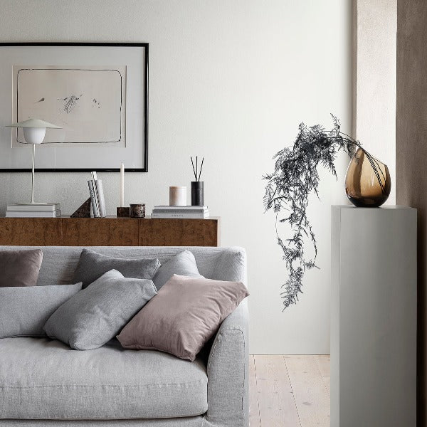 blomus DROP smoked glass designer vase on a pedestal in a comfy seating area