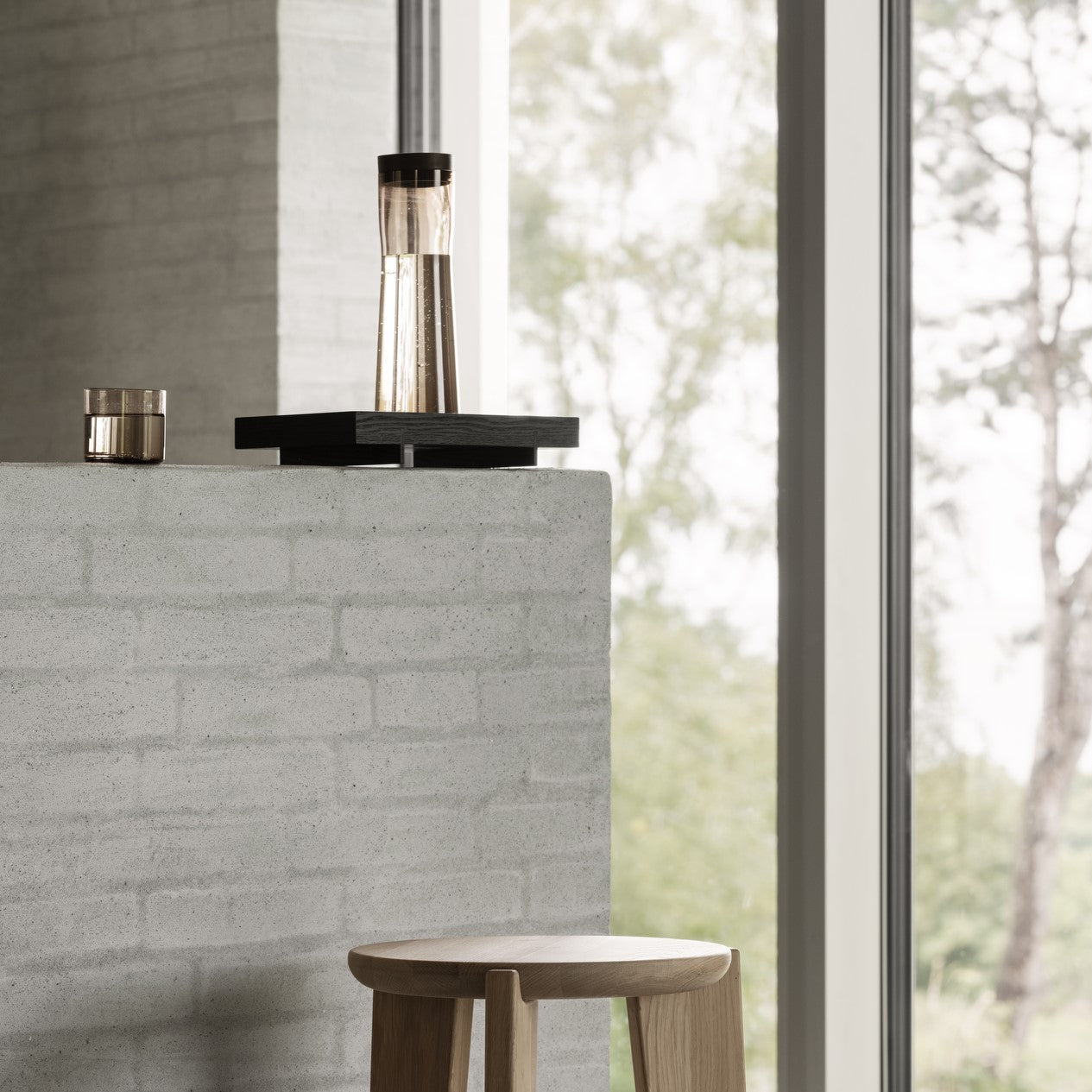 modern brick wall displaying black ABENTO serving tray by blomus
