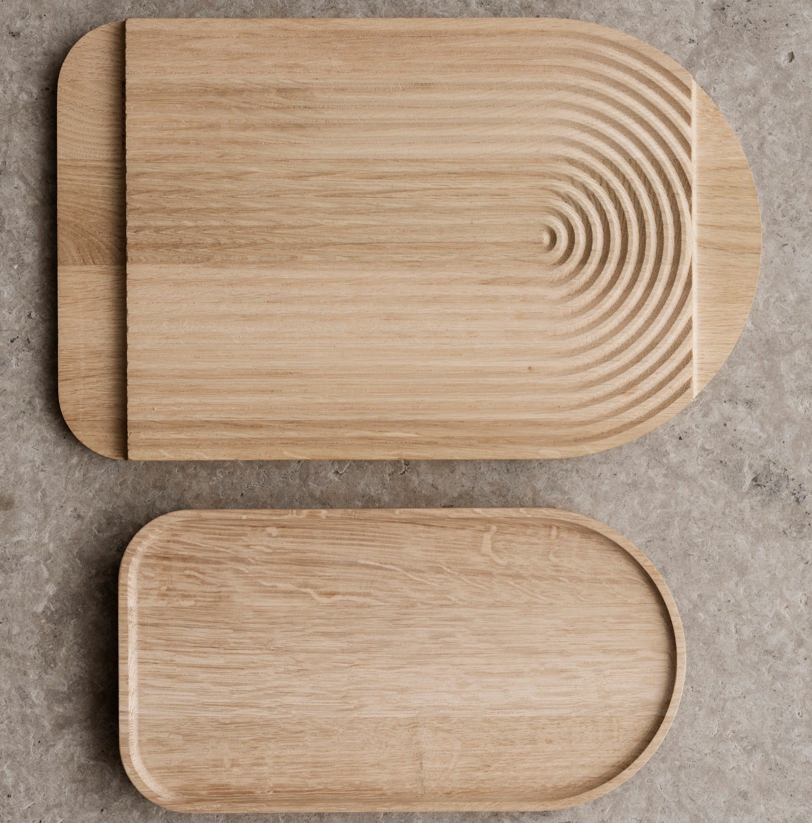 blomus ZEN cutting board and serving tray highlighting its dual use by showing the top and bottom