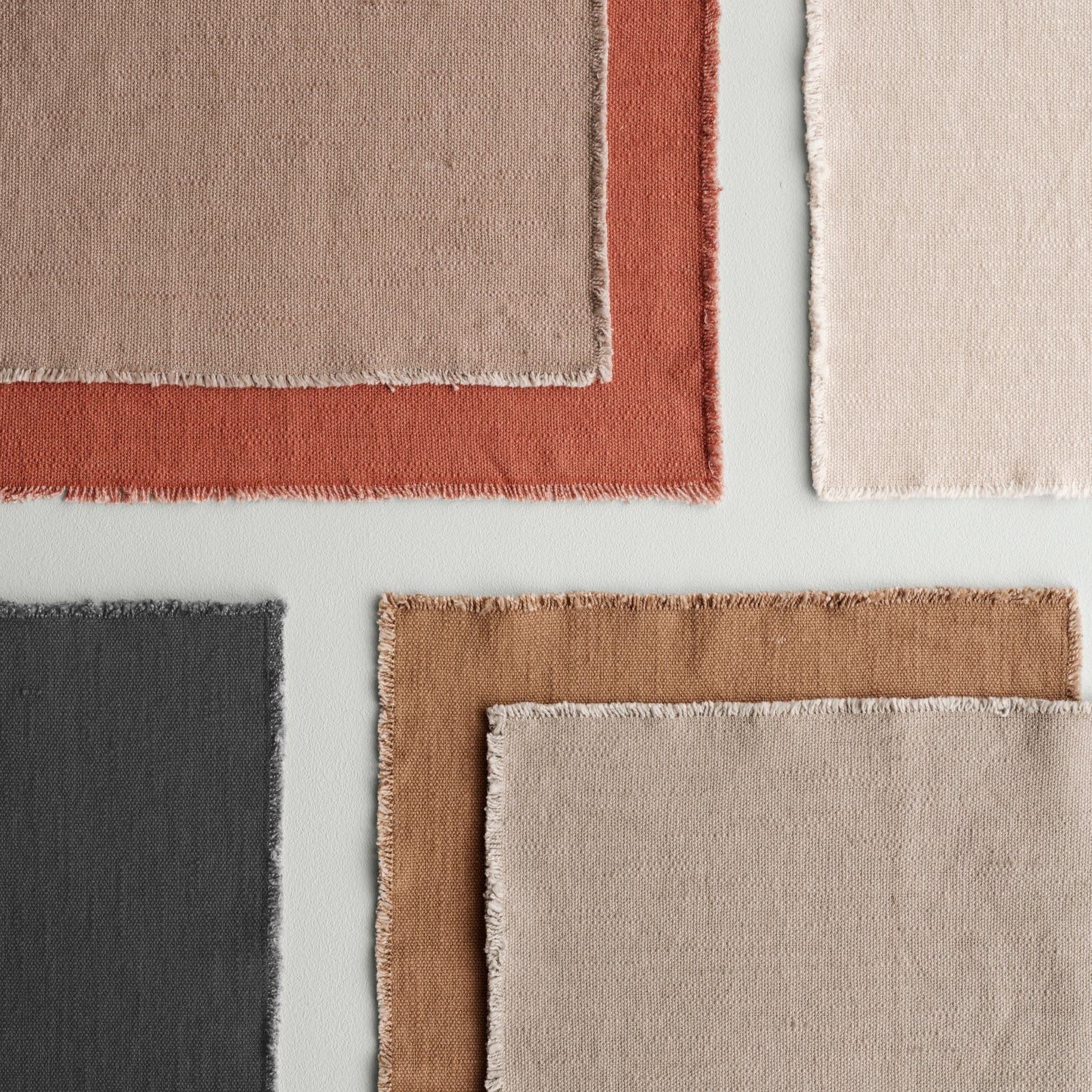 blomus LINEO cotton placemats with frayed edges layered to display available colors