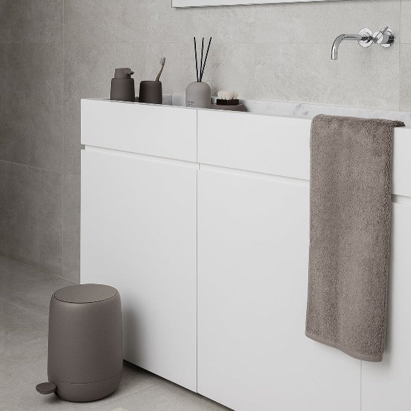 Modern minimalist bathroom sink with marble walls and fragrance diffuser from blomus