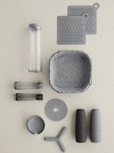 blomus FLIP trivet hot pad displayed with other kitchen accessories on an off white background
