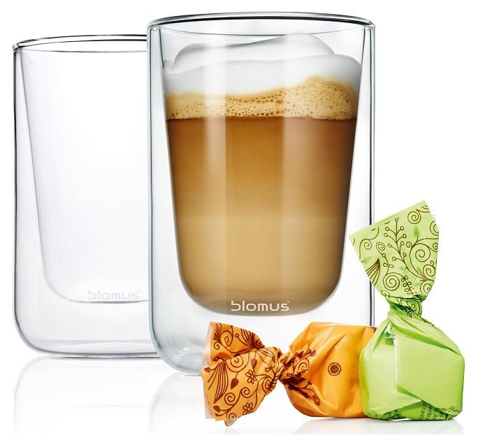 whip cream topped latte in an insulated glass from blomus NERO collection next to wrapped candies