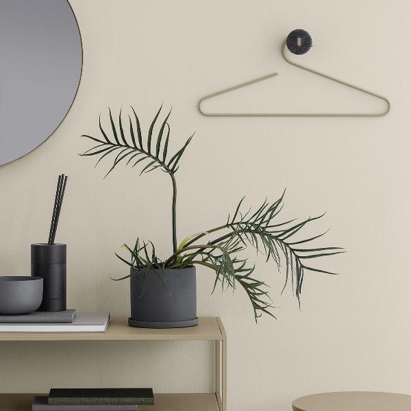 decorative porcelain herb pot by blomus NONA on a tan side table
