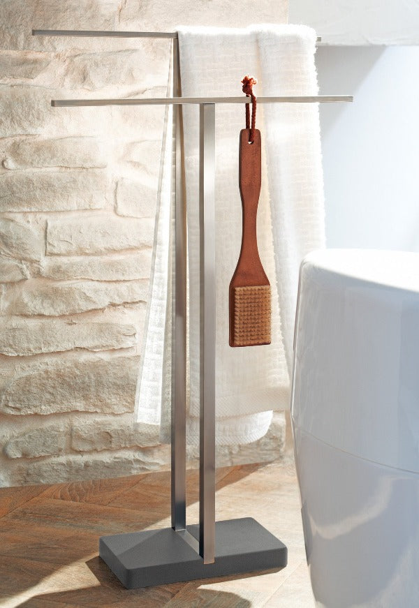 free standing brushed stainless steel towel rack from blomus in a rustic modern bathroom