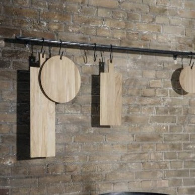 BORDA oak cutting boards by blomus hanging against a rustic brick wall