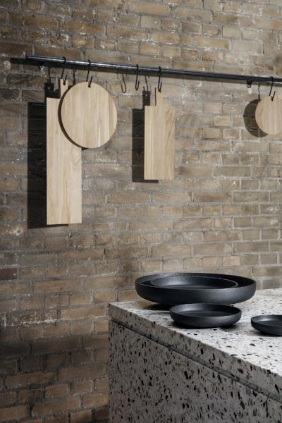 blomus BORDA wood cutting boards hanging in an industrial kitchen setting