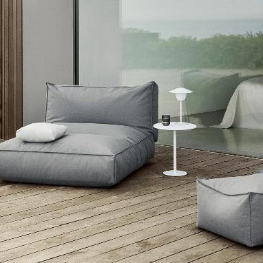 Patio lounge area with comfy seating and outdoor table lamp on side table