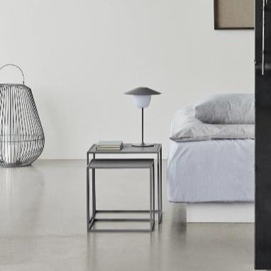 Urban bedroom with minimalist side table and lamp