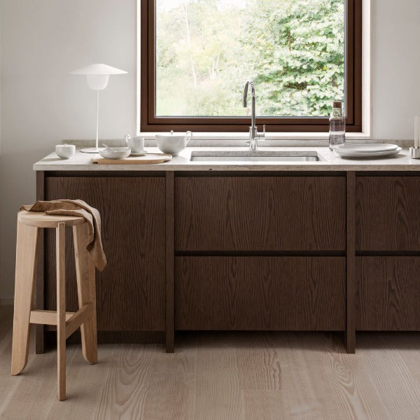 elegantly simple kitchen area with solid oak ELI bar stool from blomus