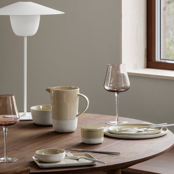 Lifestyle photo of blomus SABLO dishware in Savannah beige arranged on a modern table setting