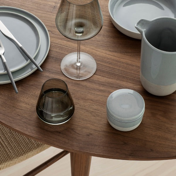 mid century modern walnut dining table with minimalist SABLO ceramic stoneware by blomus