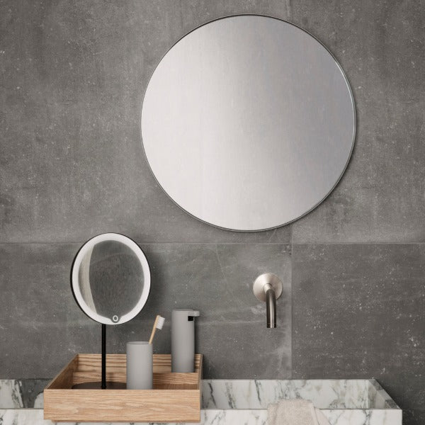 Industrial modern bathroom with wood tray displaying blomus soap dispenser and tumbler from MODO collection