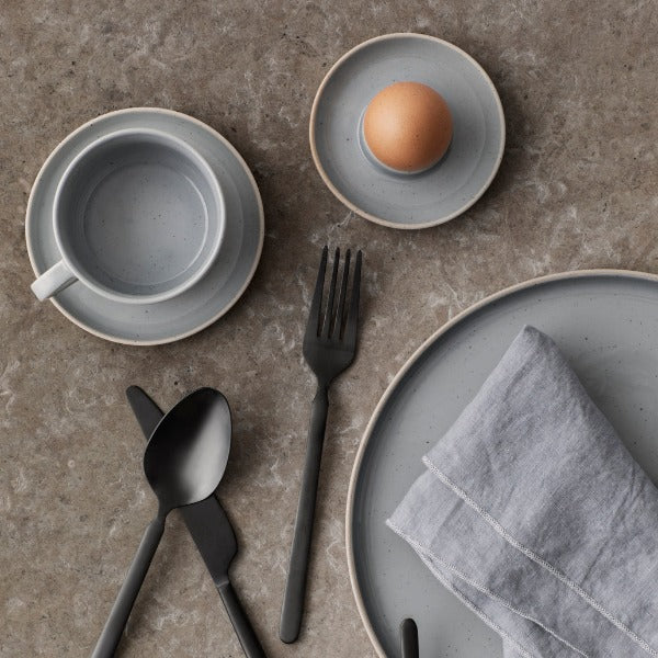 marble dining table setting featuring blomus SABLO stoneware eggcup, coffee cup and plate for modern minimalist breakfast