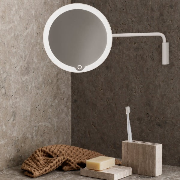 Wall mounted led bathroom mirror in a marble bathroom