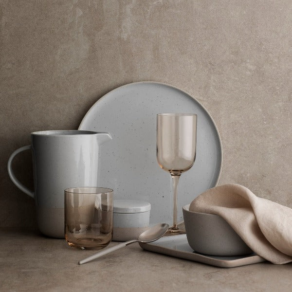 blomus SABLO stoneware arranged with modern FUUMI glassware on a classic minimalist marble backdrop