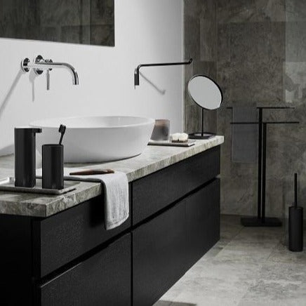 Chic marble bathroom setting with elegant black metal toilet brush and other accessories from blomus MODO collection