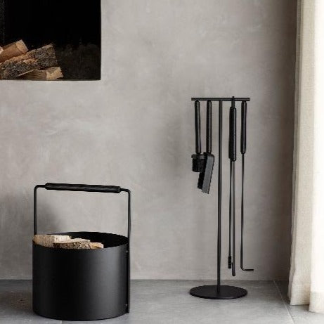 Modern living room fireplace with decorative fireplace accessories and wood basket from blomus ASHI collection