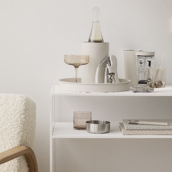 simple UTILO bottle opener displayed on white shelves with blomus wine accessories