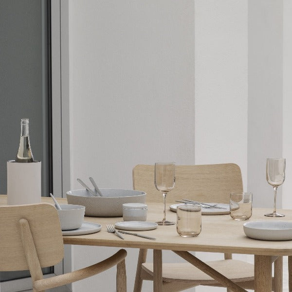 minimalist wooden dining table featuring blomus EASY wine bottle cooler
