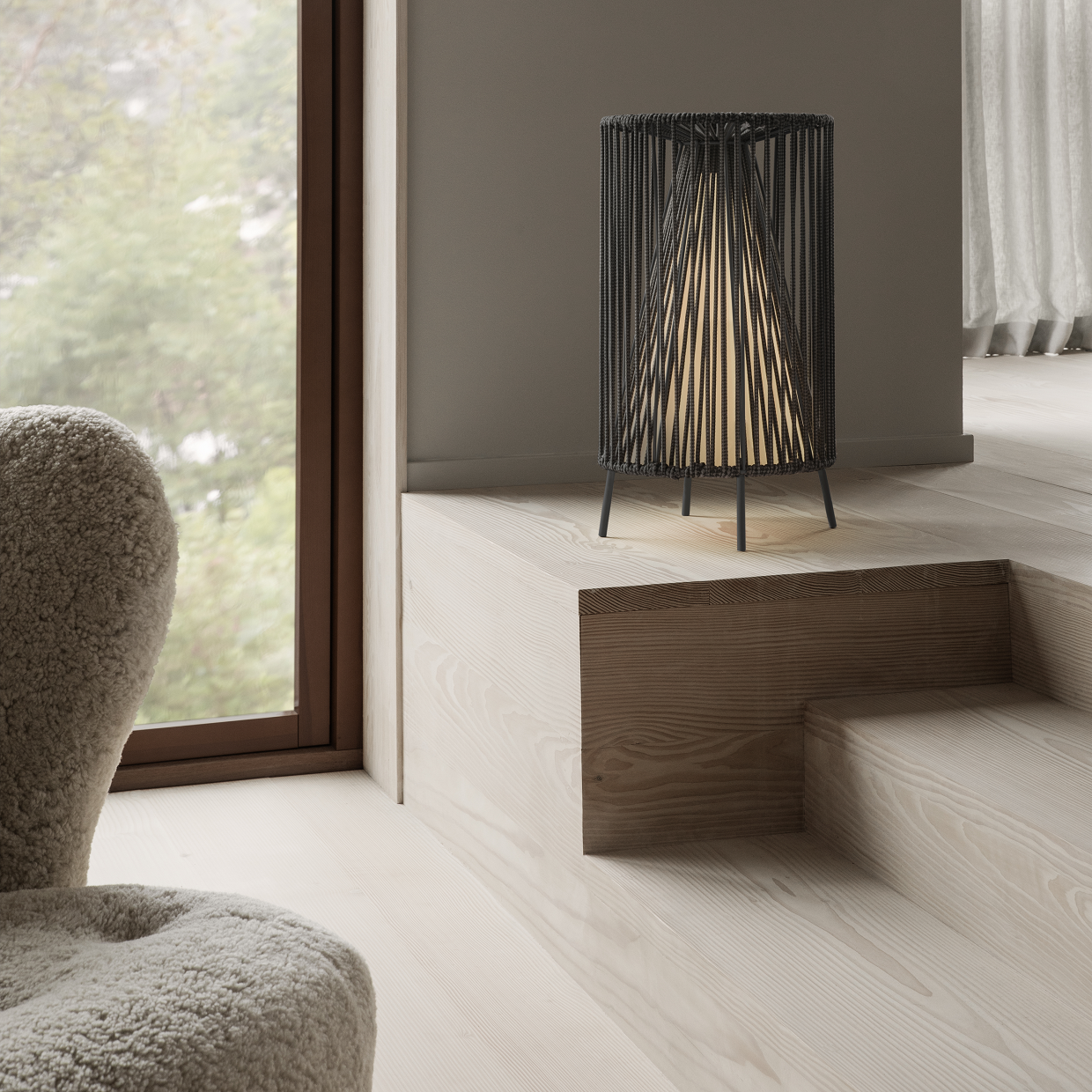 Minimalist living area with wooden floors and artistic led rope light