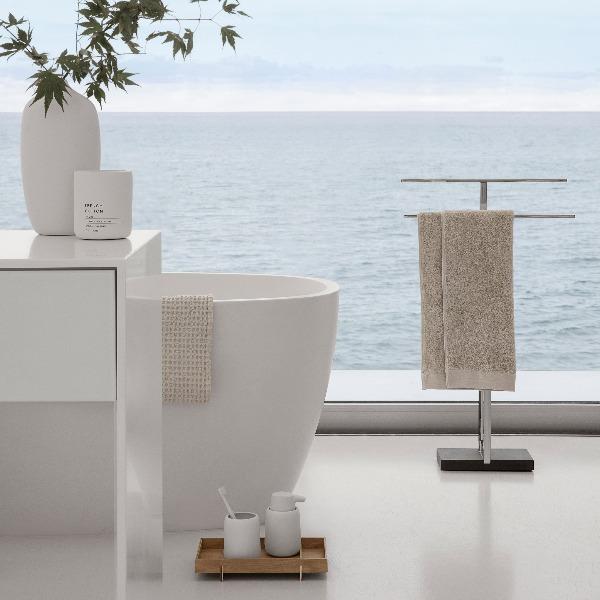 white CEOLA vase in a bathroom with large window and ocean view