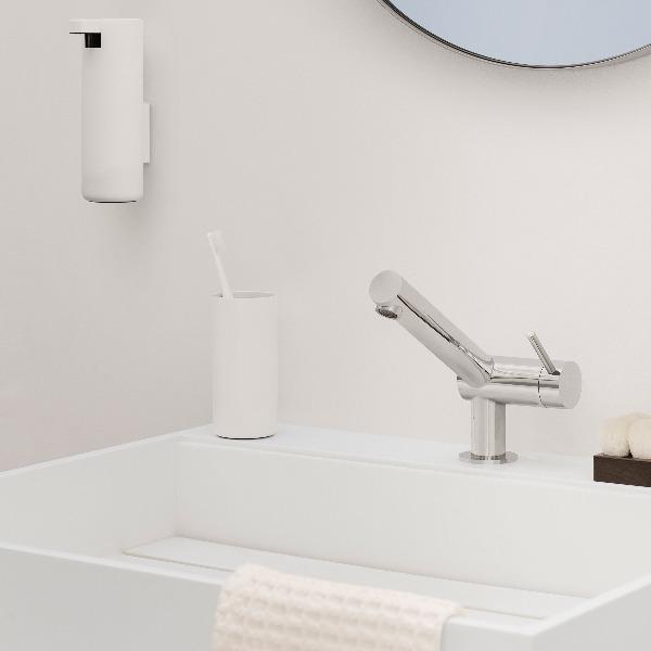 blomus wall-mounted soap dispenser in a minimalist white finish above a white sink